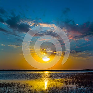 sunset reflected in a calm lake