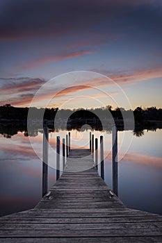 Sunset Reflected Under Wood Dock