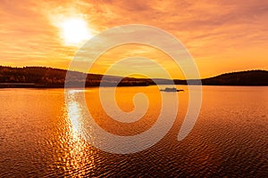 Sunset reflected in water. Josefuv Dul Dam, Jizera Mountains, Czech Republic