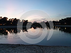 Sunset reflecting on a lake at park `t Loo in Oldebroek in the Netherlands.