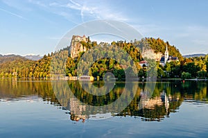 Sunset reflection of a castle in Slovenia - lake Bled in the water.