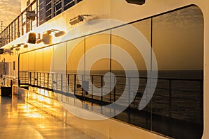 Sunset reflection on deck of an ocean cruise ship