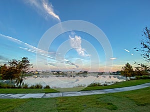 Sunset with a reflection on a lake in a neighborhood