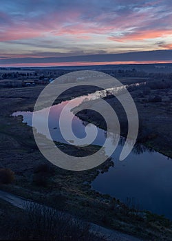 Sunset on the river, dusk, view from the high shore