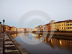 Sunset by the river in Pisa, Italy.