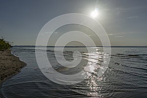 Sunset on the river Volga. Silver sunny path is reflected in the water.