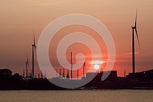 Sunset at a riverbank on a summer day, Port of Antwerp, Belgium.