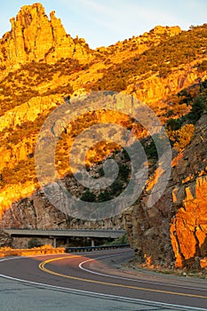 Sunset road in the deep mountain hills in tuscon arizona during desert dry season sunset with hazy blue and white sky