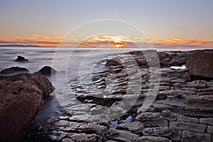 Sunset on the rocks of Rancho Palos Verdes, California photo