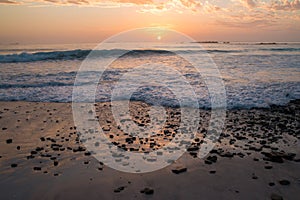 Sunset on rocky beach