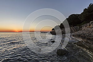 Sunset rocky beach in Istra, Croatia.