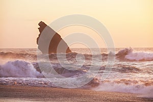 Sunset at rocky coastline of Adraga beach