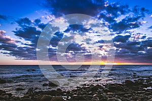 Sunset on rocky Meloneras beach, Canary Islands photo