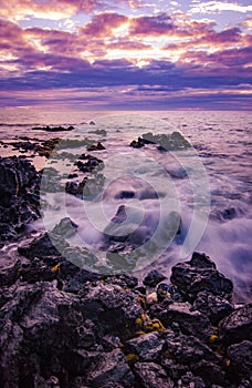 Sunset on rocky shore of Hawaii