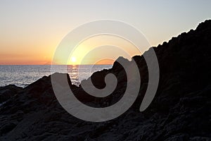 Sunset on the rocky shore. Tyrrhenian Sea