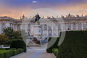 Sunset by the Royal Palace or Palacio Real with king Philip IV statue in Plaza de Oriente in Madrid Spain built in 1639