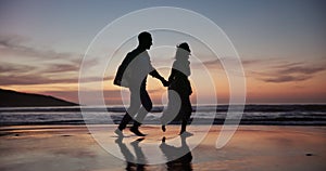 Sunset, running and silhouette of couple at beach on vacation, adventure or holiday for romance date. Love, holding