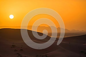 Sunset in Sahara Desert photo