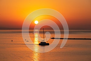 Sunset sail unfurls along the idyllic Omis Riviera, Adriatic Mediterranean Sea. Dramatic hues paint the sky as a romantic day