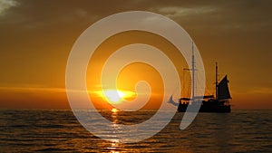 Sunset and sailing ship on the sea