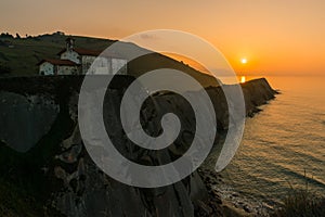 Sunset at San Telmo Church and cliffs in Zumaia