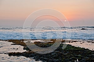 Sunset scene at Tanah Lot beach in Bali Indonesia evening