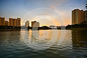 Sunset scenery over the lake with city background.