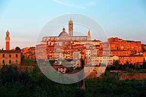 Sunset scenery of Siena, a beautiful medieval town on a hilltop in Tuscany Italy, with a view of architectural landmarks, Mangia T