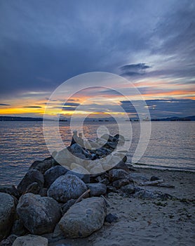 Sunset scenic over the beach with rocks. Beautiful sunset at the Pacific ocean Canada