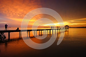 Sunset scenic view at seascape with long pier background