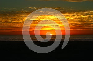 A couple watching sunset on the beach