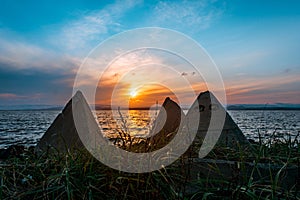 Sunset by the sea with breakwaters