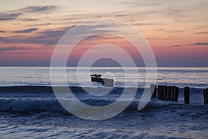 Sunset on the sea, breakwaters