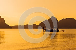 Sunset sea calm ocean with silhouette of fishing boat