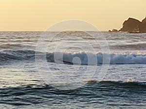 Sunset at sea with calm waves. bottom rocks