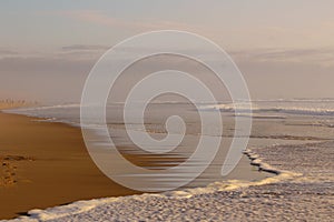 Sunset at the sea. Footprints in the sand. The sea, evening. Calm down. Rest on the sea.