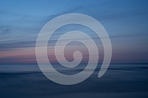 Sunset at sea, light blue sky