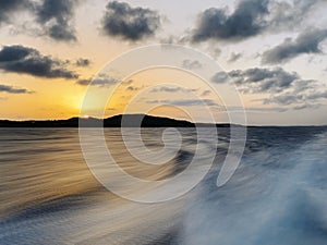 Sunset on the sea with long exposure from a boat