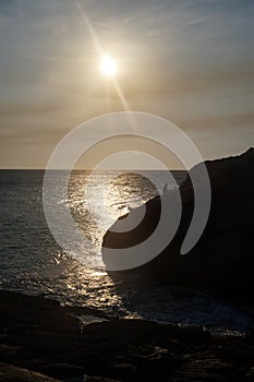 Sunset between sea and mountain arraial of cabo rio de janeiro