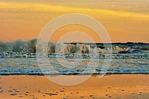 Sunset in the sea nature landscape outdoors seascape beach waves, orange sky in the background, summer season photo