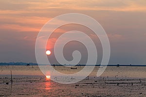 Sunset at the sea with orange, yellow, red and pink sky