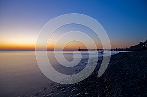 Sunset sea and pier mysterious water