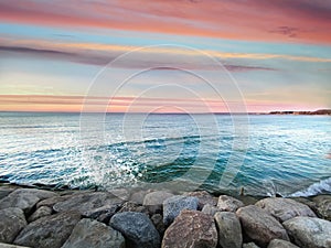 Exotic  sunset on sea ,pink blue clouds  horizon ,emerald green sea wave water splash on stones  ,nature landscape tropical island