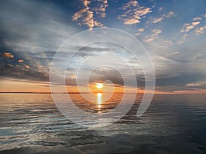 Sunset at sea pink blue gold yellow colorful sun light reflection at sea water wave clouds beautiful sky sunlight nature backgroun