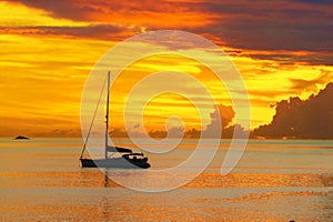 Sunset in sea and sailing yacht silhouette with beautiful landscape of Caribbean