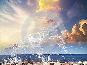 Sunset sea and sea stones on  horizon blue yellow fluffy clouds and on front water wave splash nature landscape  summer  travellin