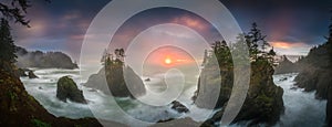 Sunset between Sea stacks with trees of Oregon coast