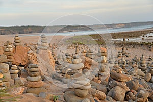 Sunset and sea stone towers at Vila Nova de Milfontes beach