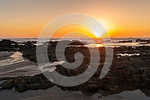 Sunset and seascape with rock formation in at Apulia beach. Parque Natural do Litoral on the north of Portugal in the vicinity of