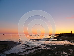 Sunset on a seaside without clouds.